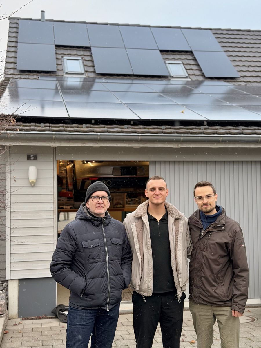Zufriedener Kunde mit Solartech vor seinem Haus mit fertiger Solaranlage